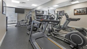 A gym with treadmills, elliptical machines, and weight equipment.