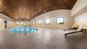 A spacious indoor pool area with a wooden ceiling, multiple windows, and lounge chairs. - Country Inn & Suites by Radisson, DFW Airport South, TX (Irving)