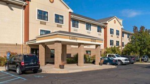A hotel with a lobby entrance, multiple parking spaces, and a brick facade. - Extended Stay America Suites Detroit Canton (Canton)