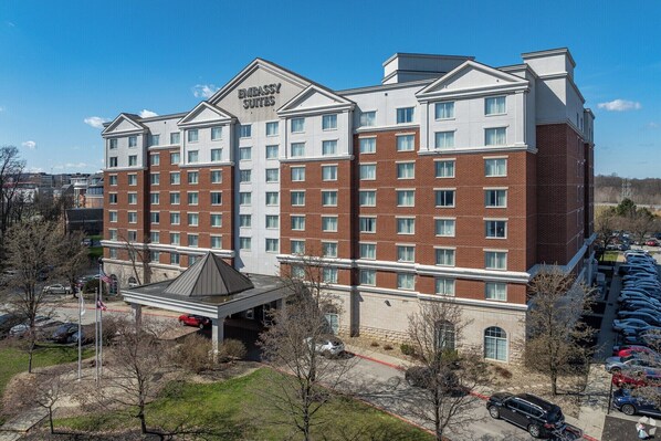 A multi-story hotel with a prominent sign reading 'EMBASSY SUITES.'