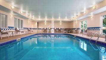 Relax by the pool surrounded by a checkered deck and lounge chairs.