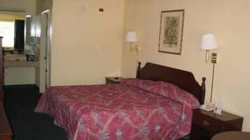 A hotel room with a bed, bedside tables, a desk, and a chair.