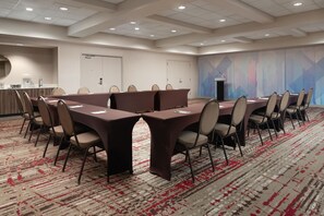 A conference room with a long table, chairs, a podium, and a patterned carpet. - Hilton Garden Inn Rock Hill (Rock Hill)