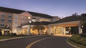 A large, multi-story hotel with a prominent entrance and a well-lit facade. - Hilton Garden Inn Bridgewater (Bridgewater)