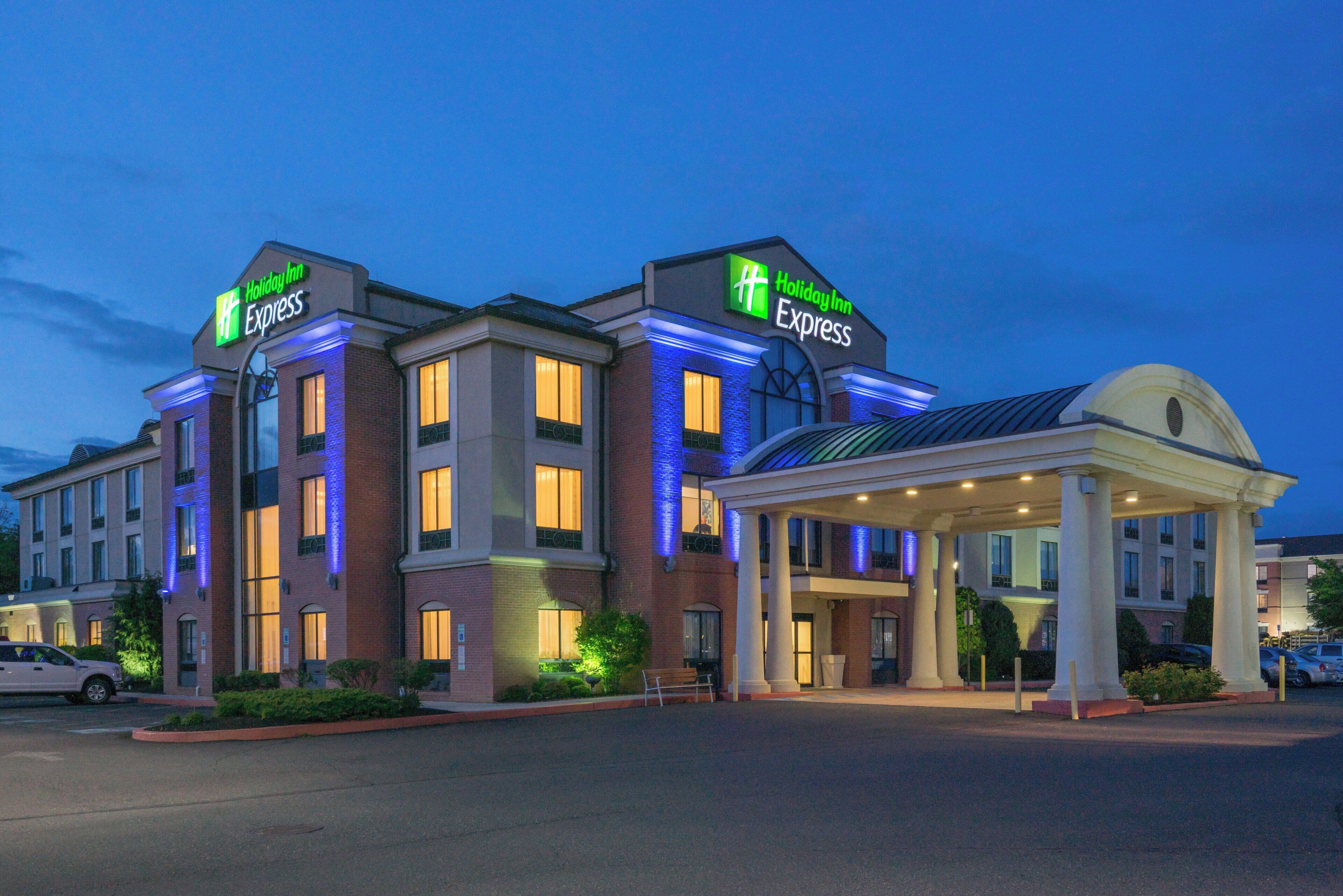 A Holiday Inn Express hotel with a two-story structure, a covered entrance, and a parking lot.