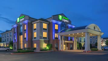 A Holiday Inn Express hotel with a two-story structure, a covered entrance, and a parking lot.