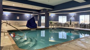 An indoor swimming pool with clear markings, a covered area, and seating by the windows. - Holiday Inn Express Boonville by IHG (Boonville)