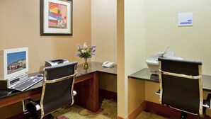 A hotel room with a desk, two chairs, a printer, a phone, a framed picture, and a 'No Smoking' sign. - Holiday Inn Express Boonville by IHG (Boonville)