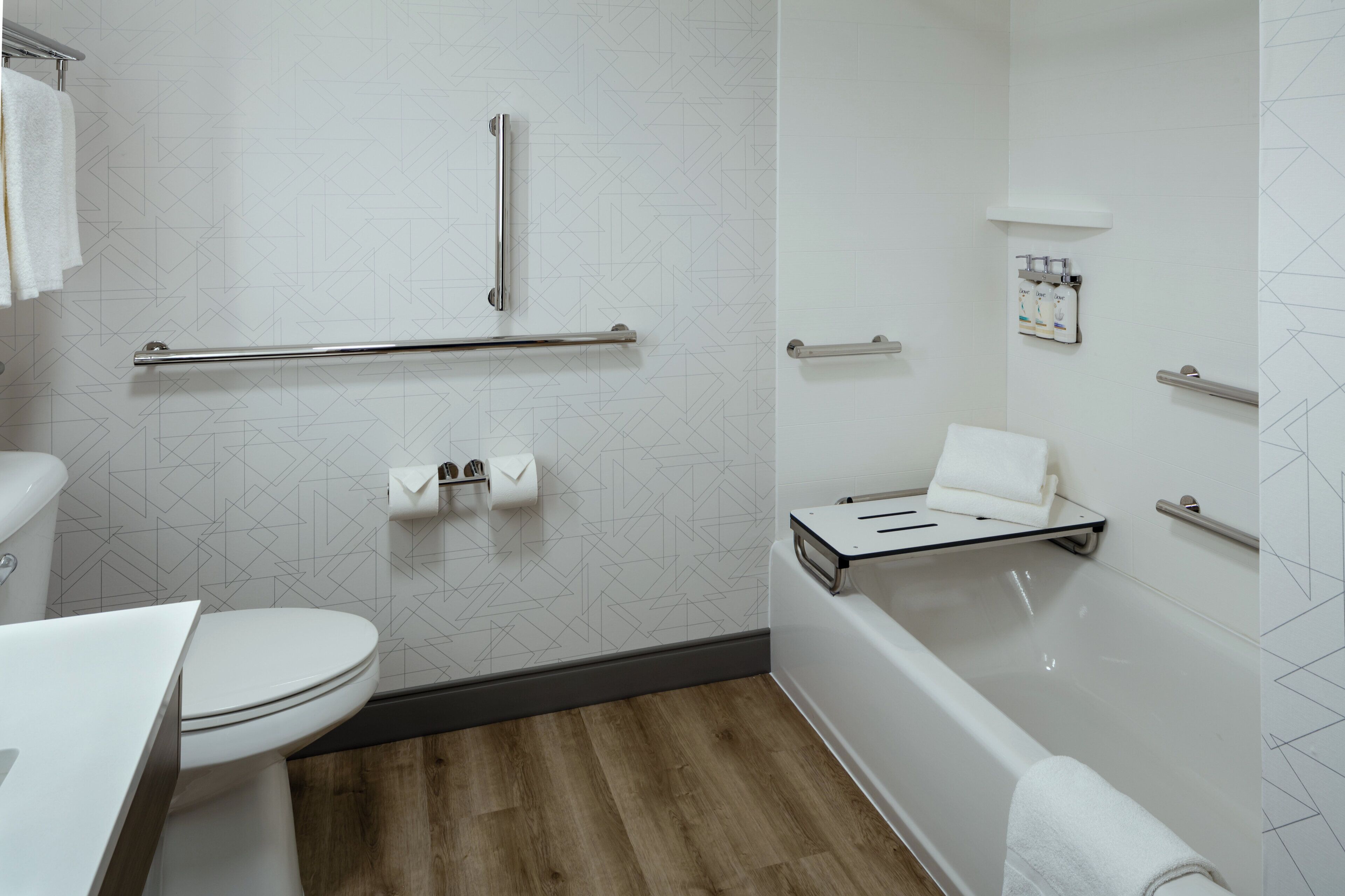A modern bathroom with a toilet, bidet, and bathtub.