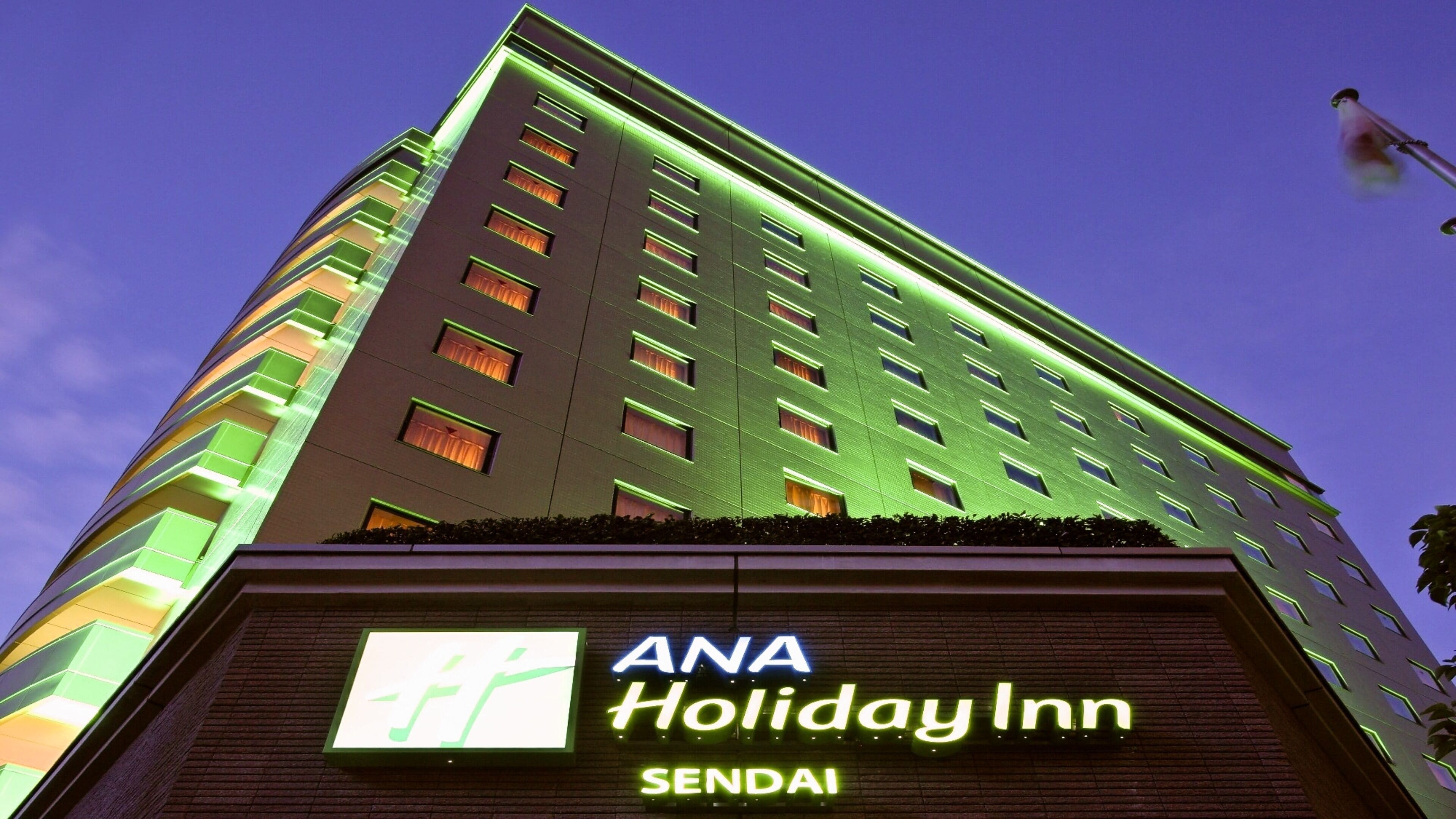 Un edificio alto con un cartel de ANA Holiday Inn Sendaí.