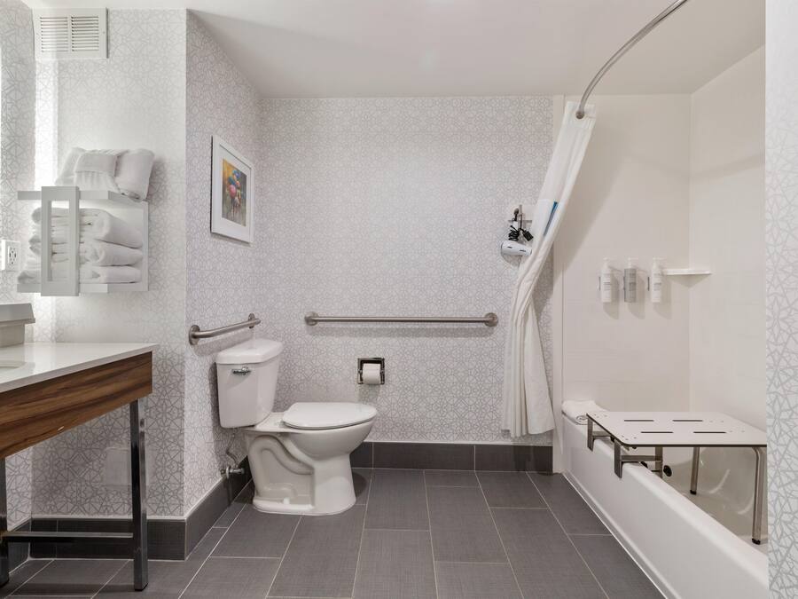 A modern bathroom with a toilet, sink, and shower area.