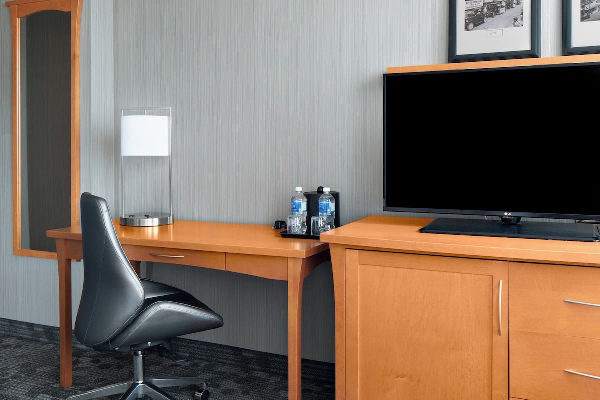Relax in a well-appointed room with a desk, flat-screen TV, and comfortable seating.