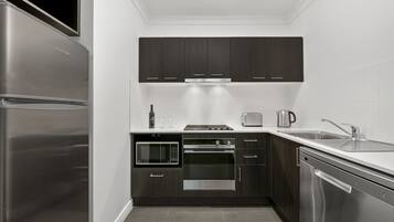 Executive One Bedroom Apartment | Private kitchen | Fridge, microwave, stovetop, dishwasher