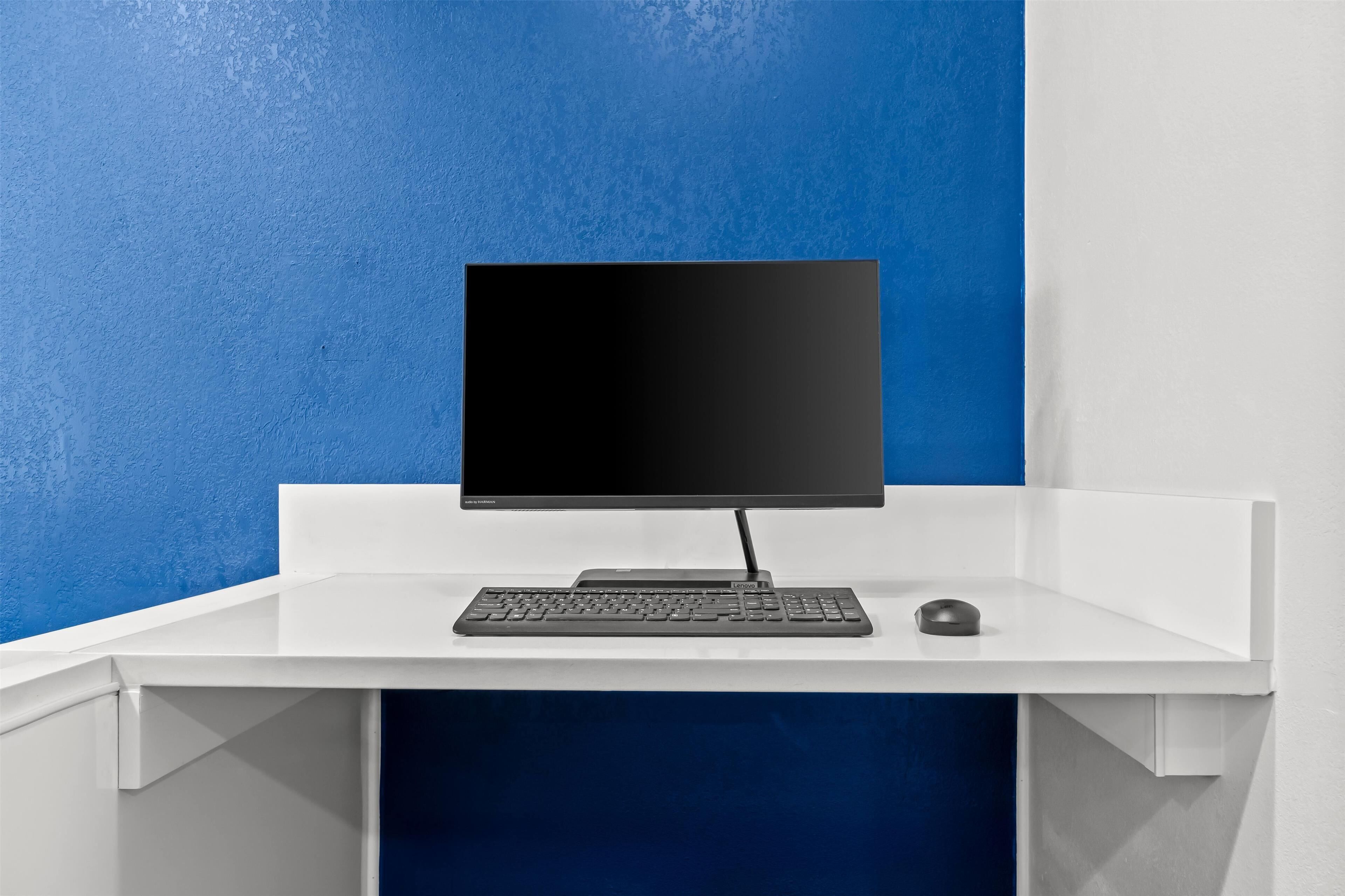Un escritorio con monitor, teclado y ratón.