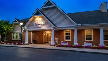 A brick building with a sign reading "Resilience Inn."