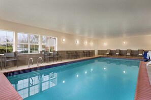 An indoor swimming pool with clear blue water, surrounded by lounge chairs and a tiled deck. - Residence Inn by Marriott Salem (Salem)