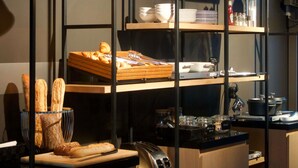 A kitchen area with bread, utensils, and a coffee machine. - Mercure St Malo Front De Mer (Saint-Malo)