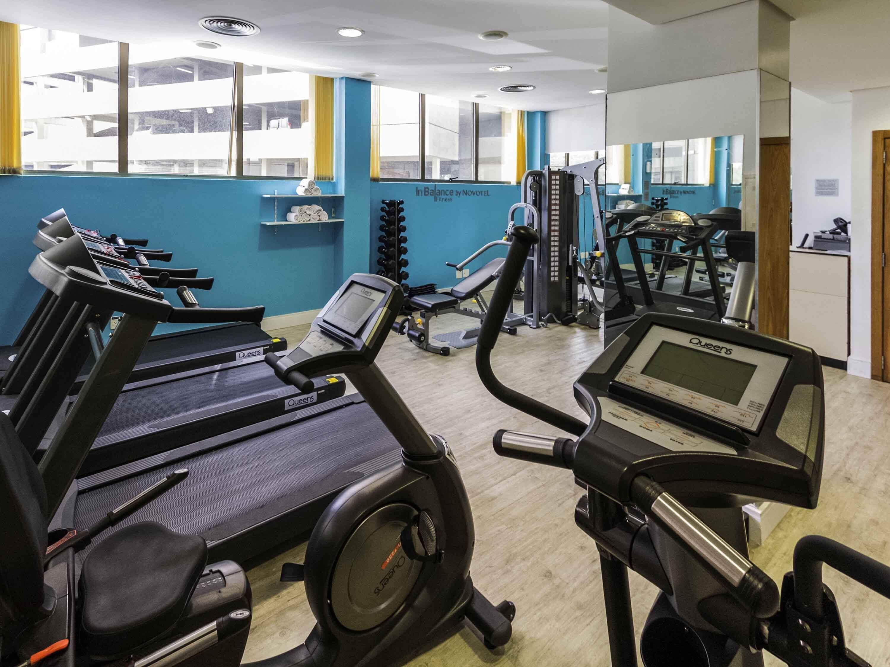 A gym with treadmills, a stationary bike, and weight machines.