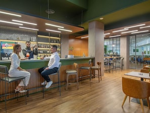 A modern bar area with wooden accents, a counter, and seating arrangements. - Novotel Porto Alegre Tres Figueiras Hotel (Porto Alegre)