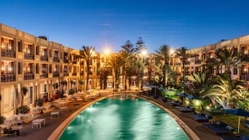 Una piscina al aire libre, sombrillas