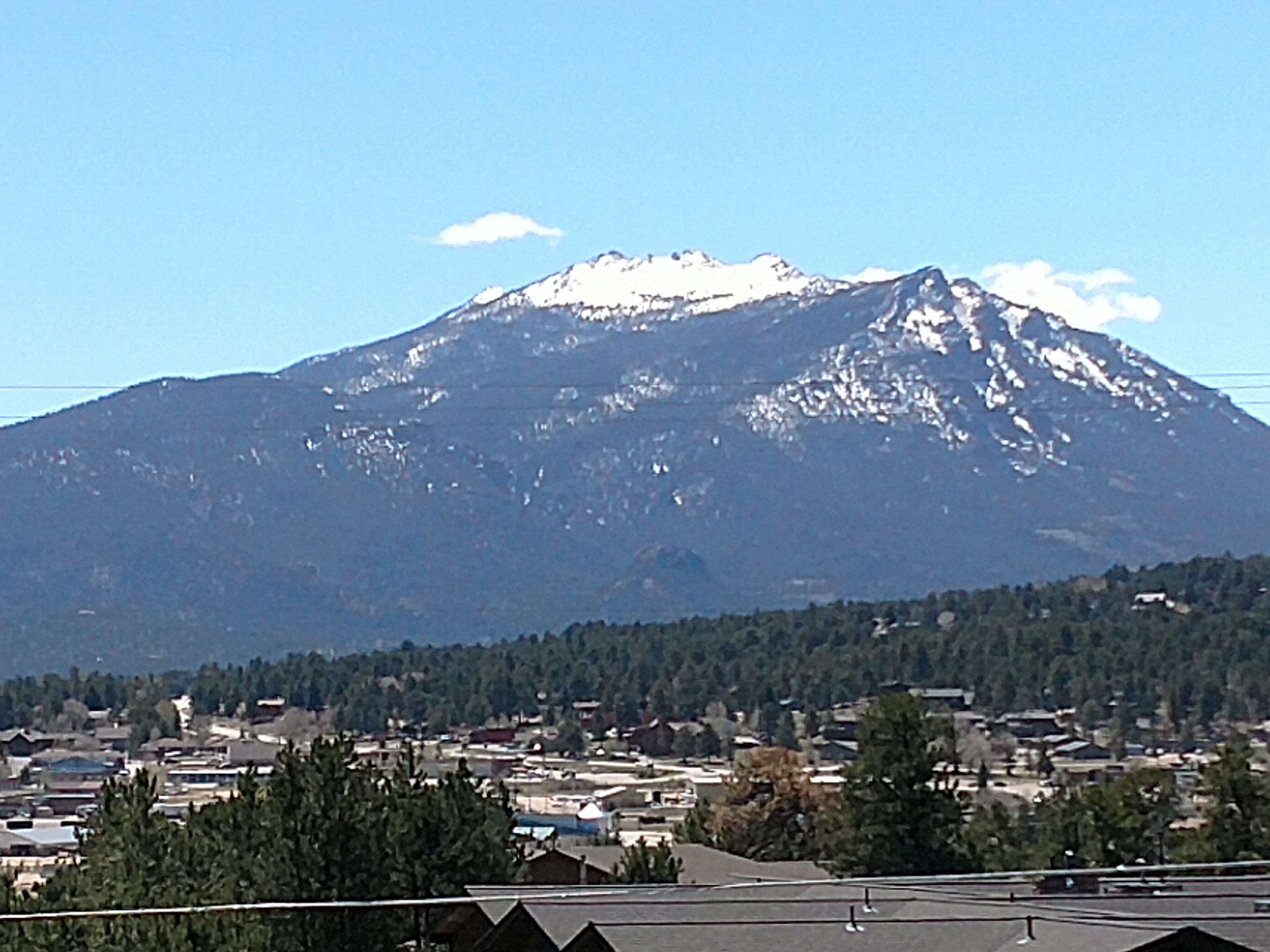 A mountain with snow-capped peaks in the background.