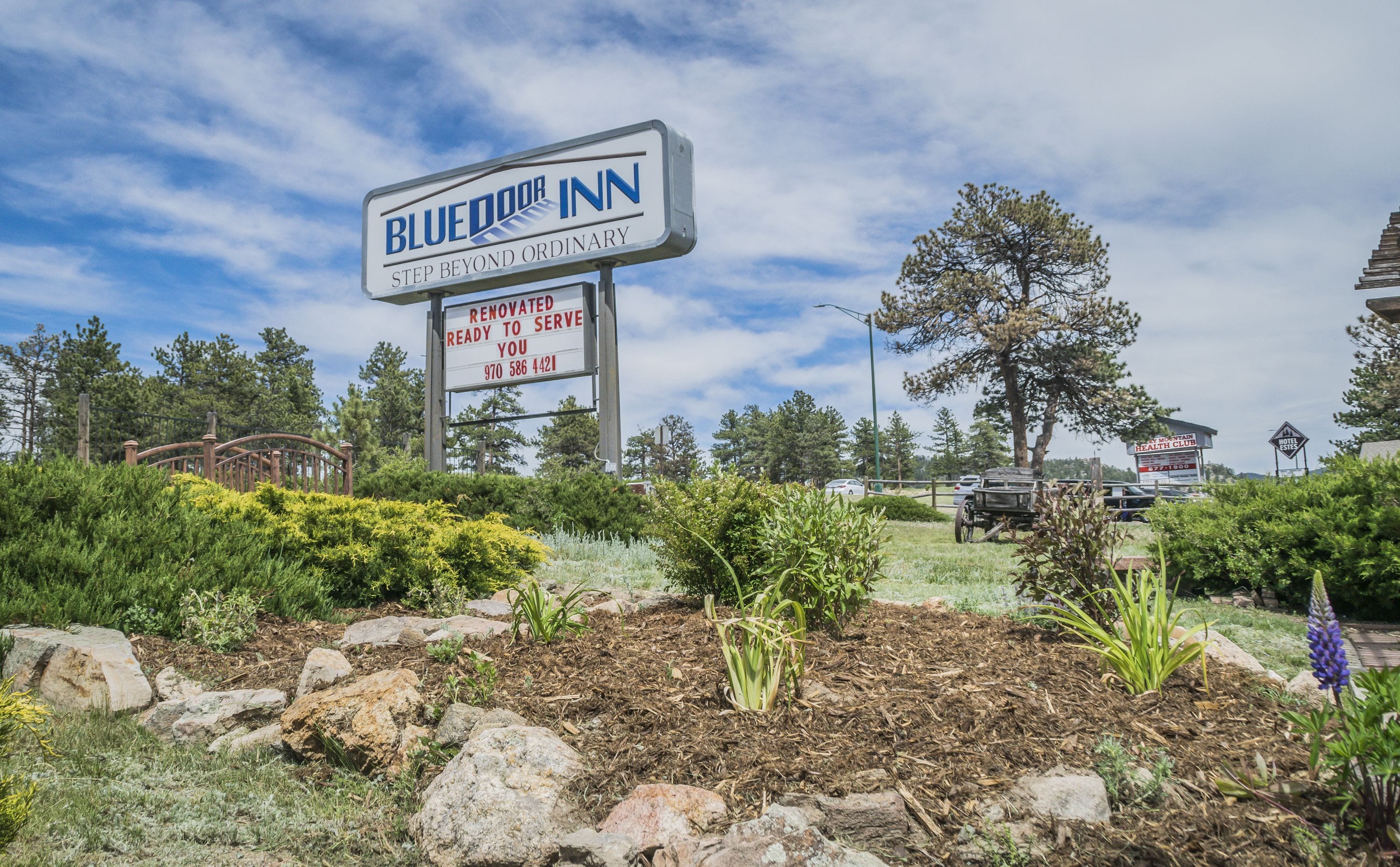 A Blue Door Inn sign with a message about renovation and a contact number.