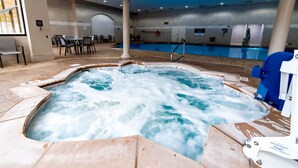 A hot tub with a pool, indoor seating area, and a view of the pool. - Caesars Southern Indiana Hotel & Casino - A Caesars Rewards Destination (Elizabeth)