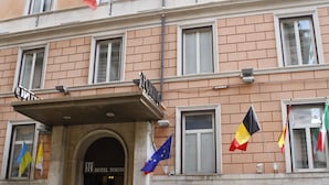 A hotel facade with multiple flags, including the European Union flag, and a sign reading "HOTEL TORINO". - Hotel Torino (Rome)