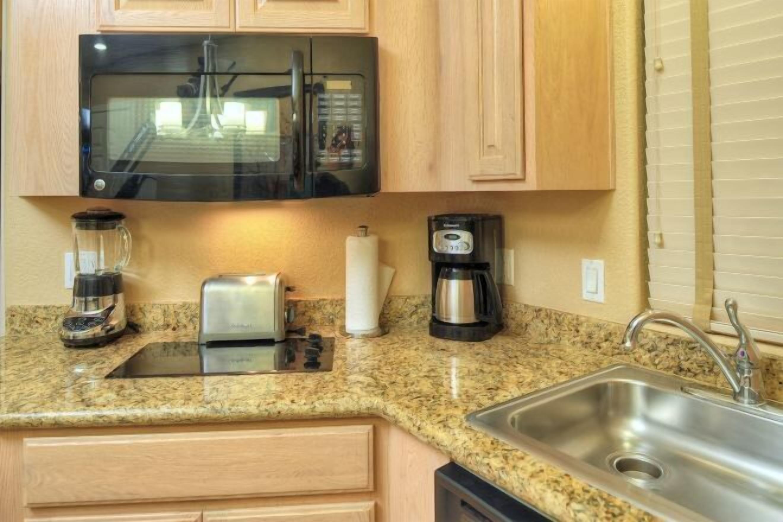 Microwave, coffee/tea maker, cookware/dishes/utensils, dining tables