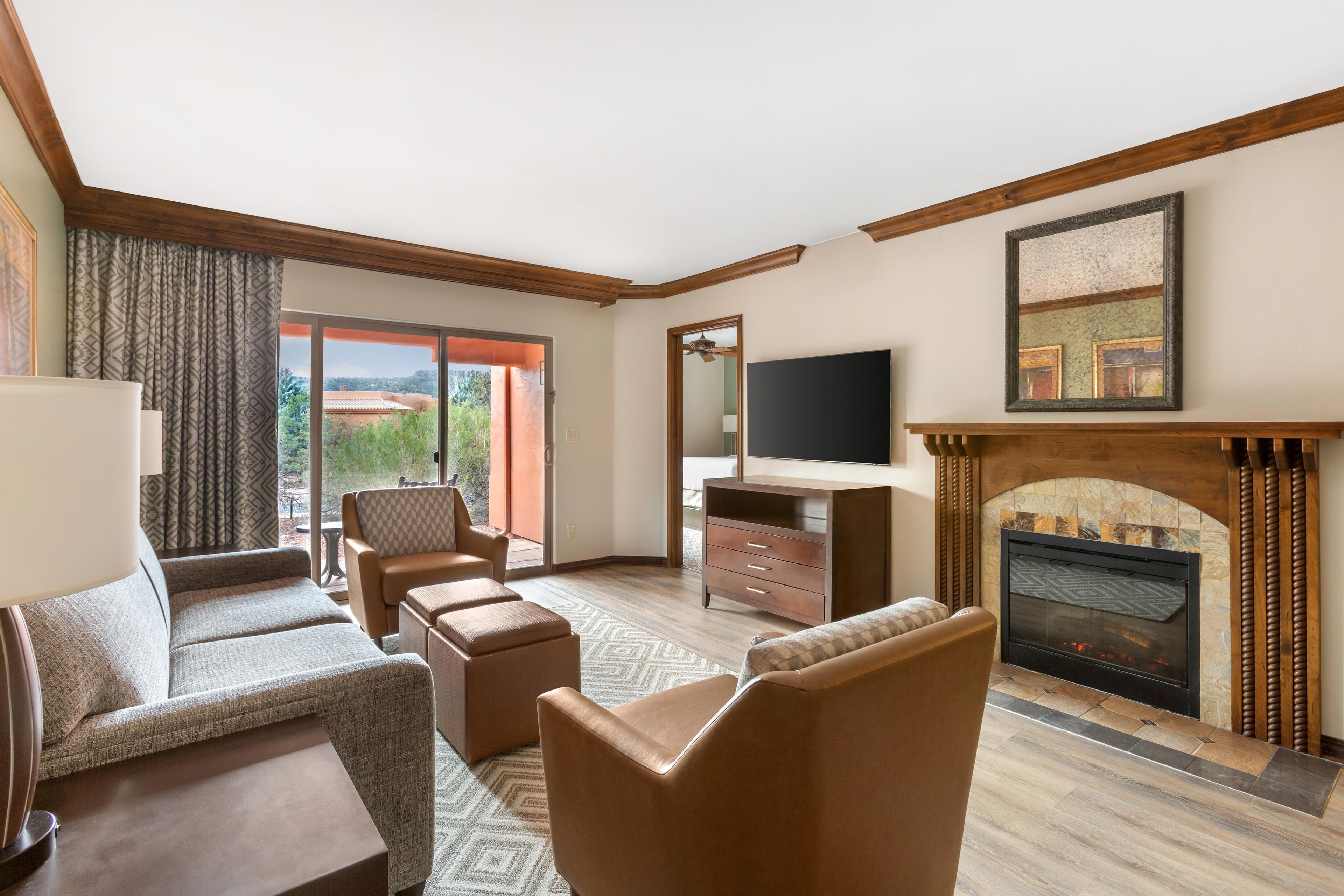A living room with a fireplace, a television, and a sofa set.