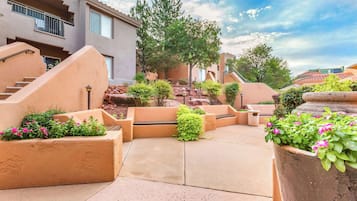 Relax in a serene courtyard with a central seating area, fountain, and lush greenery.