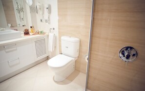 A modern bathroom with a white toilet, a sink, and a shower area. - Apart Hotel Best (Ankara)