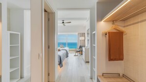 A hotel corridor with a bed, a desk, and a view of the sea. - Pestana Blue Alvor Beach - All Inclusive Hotel (Portimão)