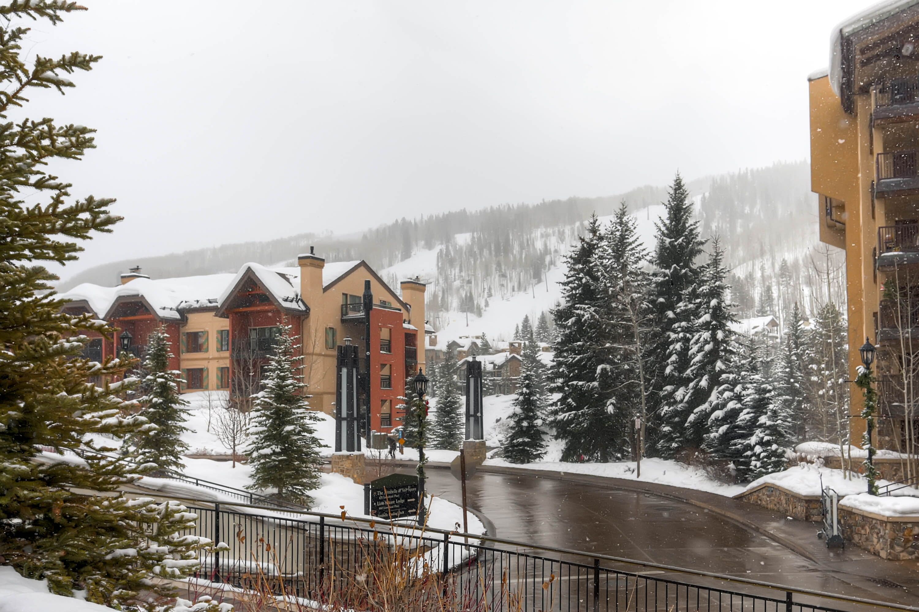 A snow-covered town with buildings and a road.