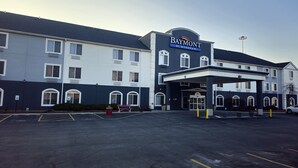 Un hotel Baymont by Wyndham con entrada cubierta, estacionamiento y múltiples ventanas.
