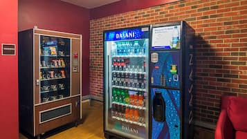 A vending machine with a variety of snacks and beverages, and a water dispenser with a digital calorie counter.