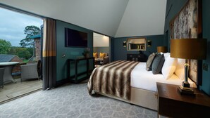 A bedroom with a bed, bedside table, lamp, and a view of the outdoors. - Aldwark Manor Estate (York)