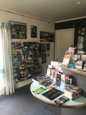 A bookstore with a variety of magazines and books on display, including children's magazines and travel guides. - Fenton Court Motel (Rotorua)