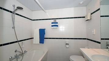 A bathroom with a bathtub, toilet, and sink.