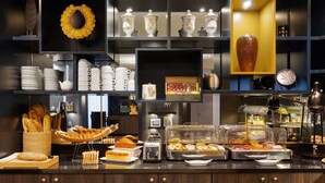 A buffet setup with various food items and kitchenware. - Best Western Plus Hotel Admiral (La Tour-de-Salvagny)
