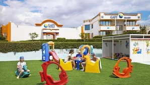 A children's play area with slides and swings at GAFY RESORT. - Gafy Resort Aqua Park (Sharm El Sheikh)