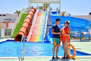 A swimming pool with multiple slides, including a rainbow-colored slide and a blue slide. - Gafy Resort Aqua Park (Sharm El Sheikh)