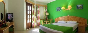 A hotel room with a bed, a television, a desk with a lamp, and a chair. - Gafy Resort Aqua Park (Sharm El Sheikh)