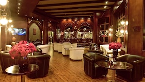 A spacious lobby with leather seating, a bar area in the background, and decorative lighting. - Gafy Resort Aqua Park (Sharm El Sheikh)