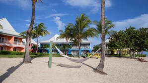 Plage privée, sable blanc, chaises longues, serviettes de plage