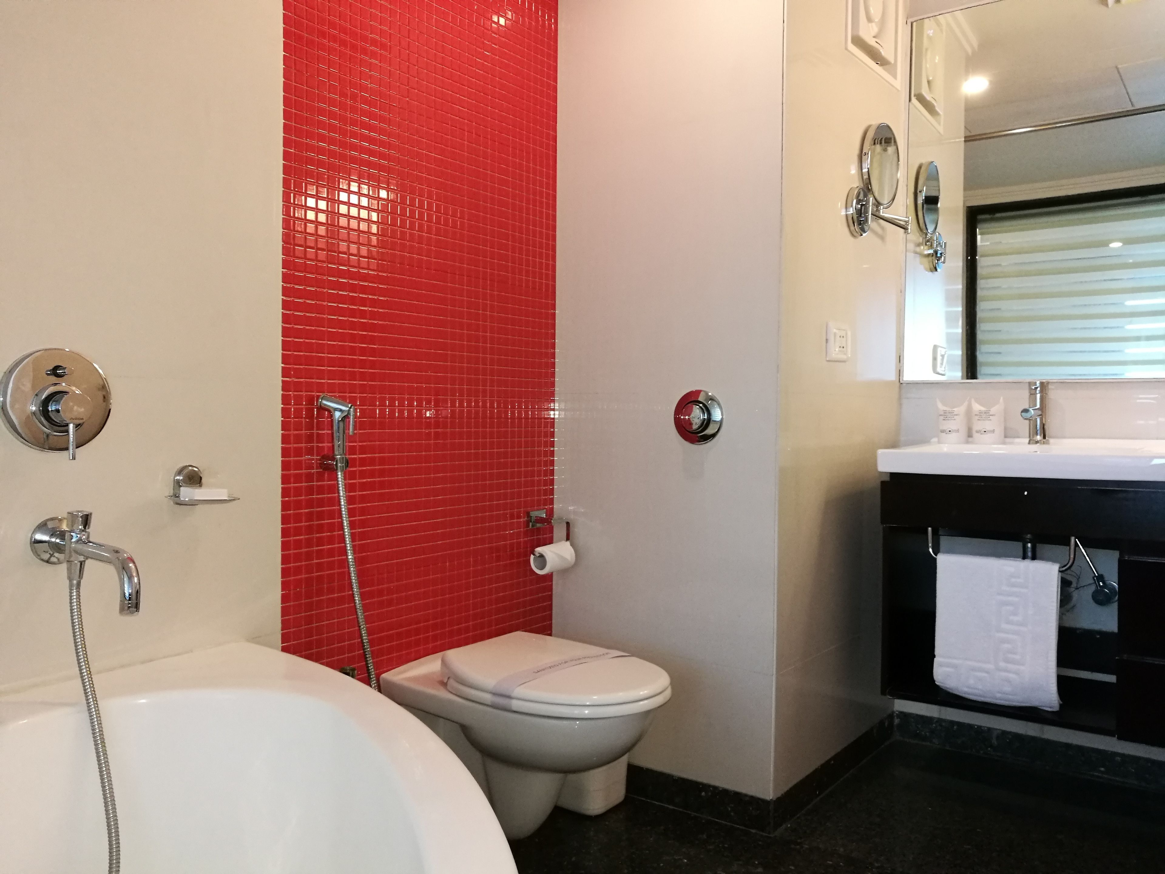 A bathroom with a bathtub, toilet, and sink.