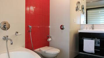 A bathroom with a bathtub, toilet, and sink.