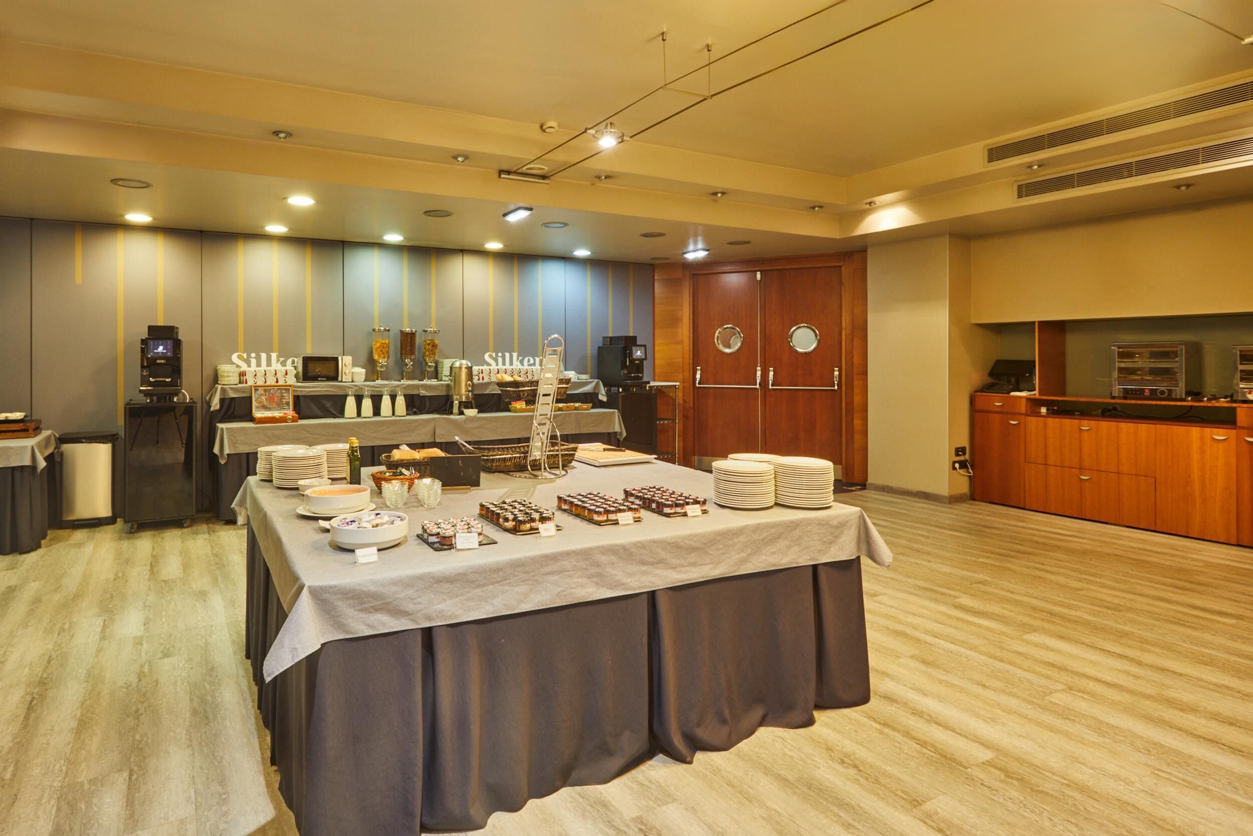 A buffet setup with a variety of food items and a coffee station.