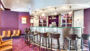 A bar area with a glass counter, bar stools, and a patterned carpet. - Villa Lutece Port Royal (Paris)