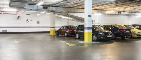 A multi-level parking garage with several cars parked.